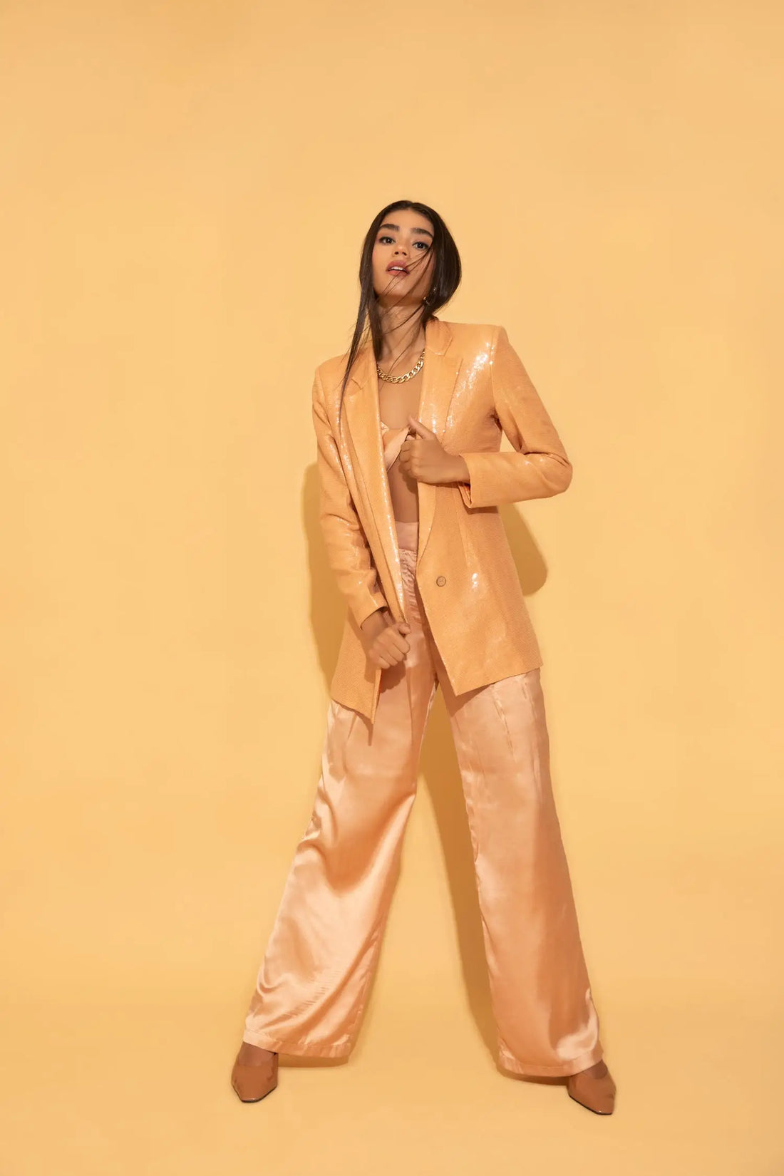 The dazzling peach set from Torqadorn, featuring sequins blazer, crop top and satin pants.