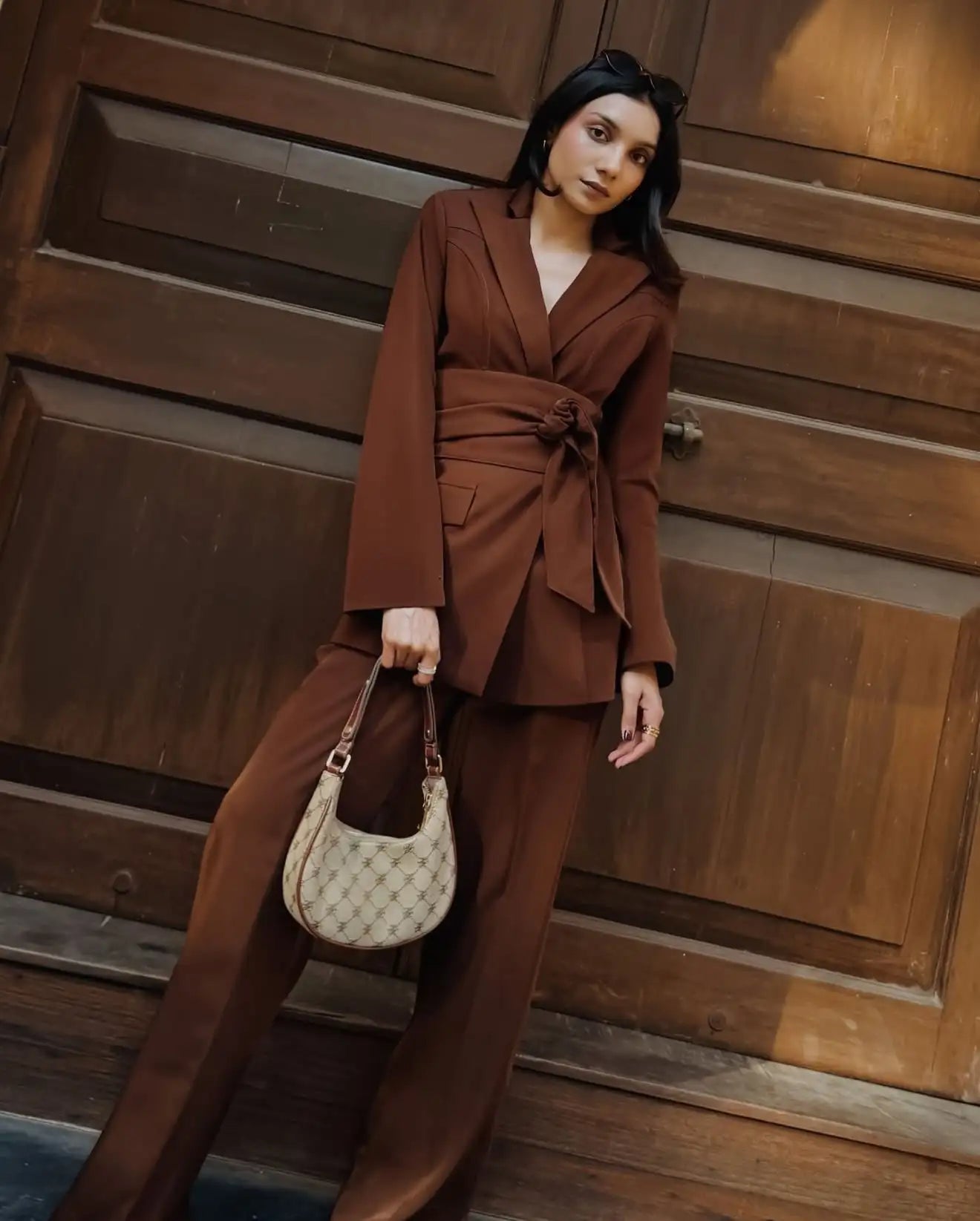 Beige and brown patterned hobo bag with a chain strap