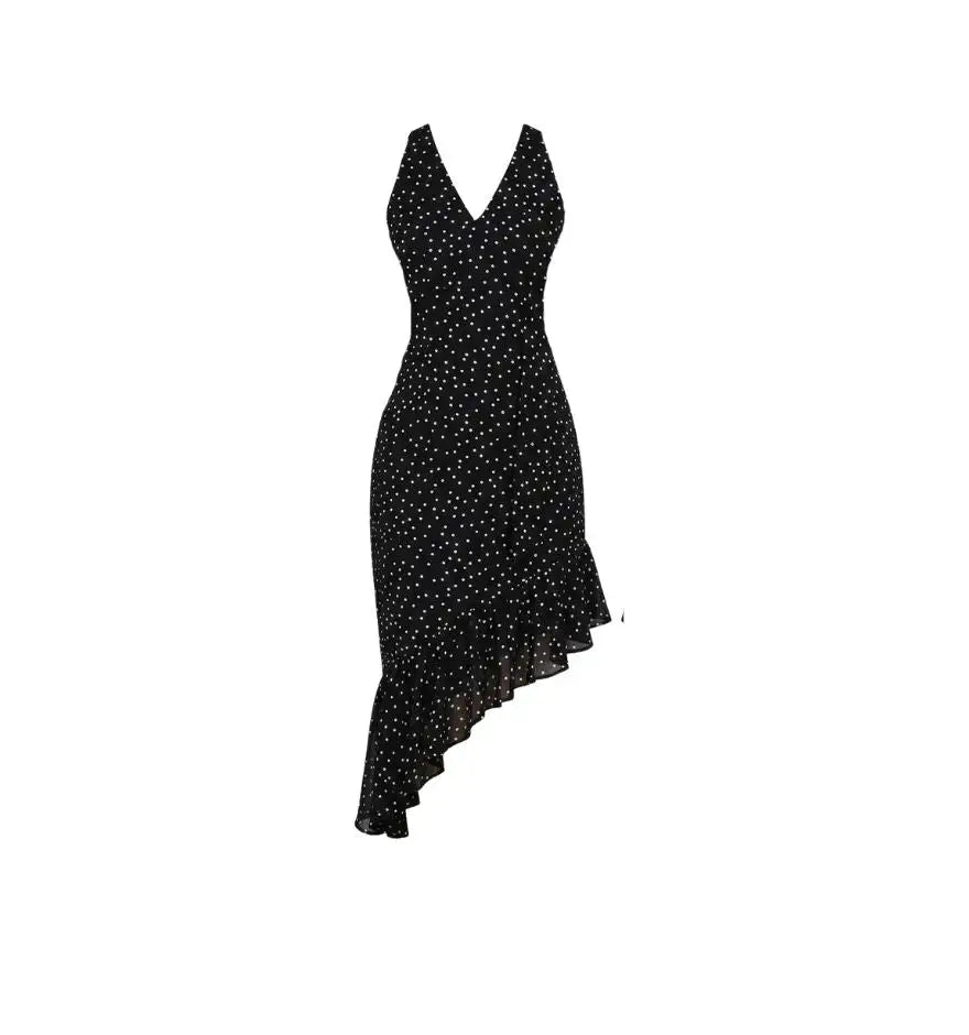 Black halter-neck dress with white polka dots and a ruffled asymmetrical hem.