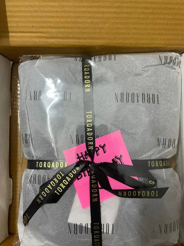 Black and white patterned scarf with ’torqadorn’ text