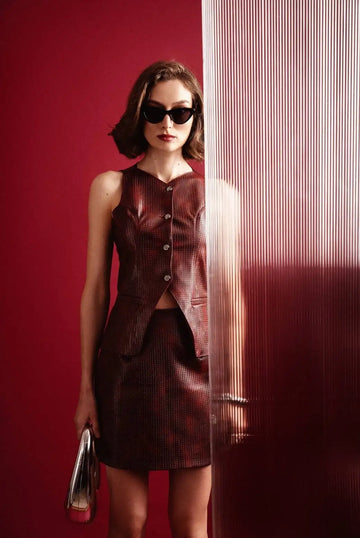 Brown pleated skirt with button detail and matching top.