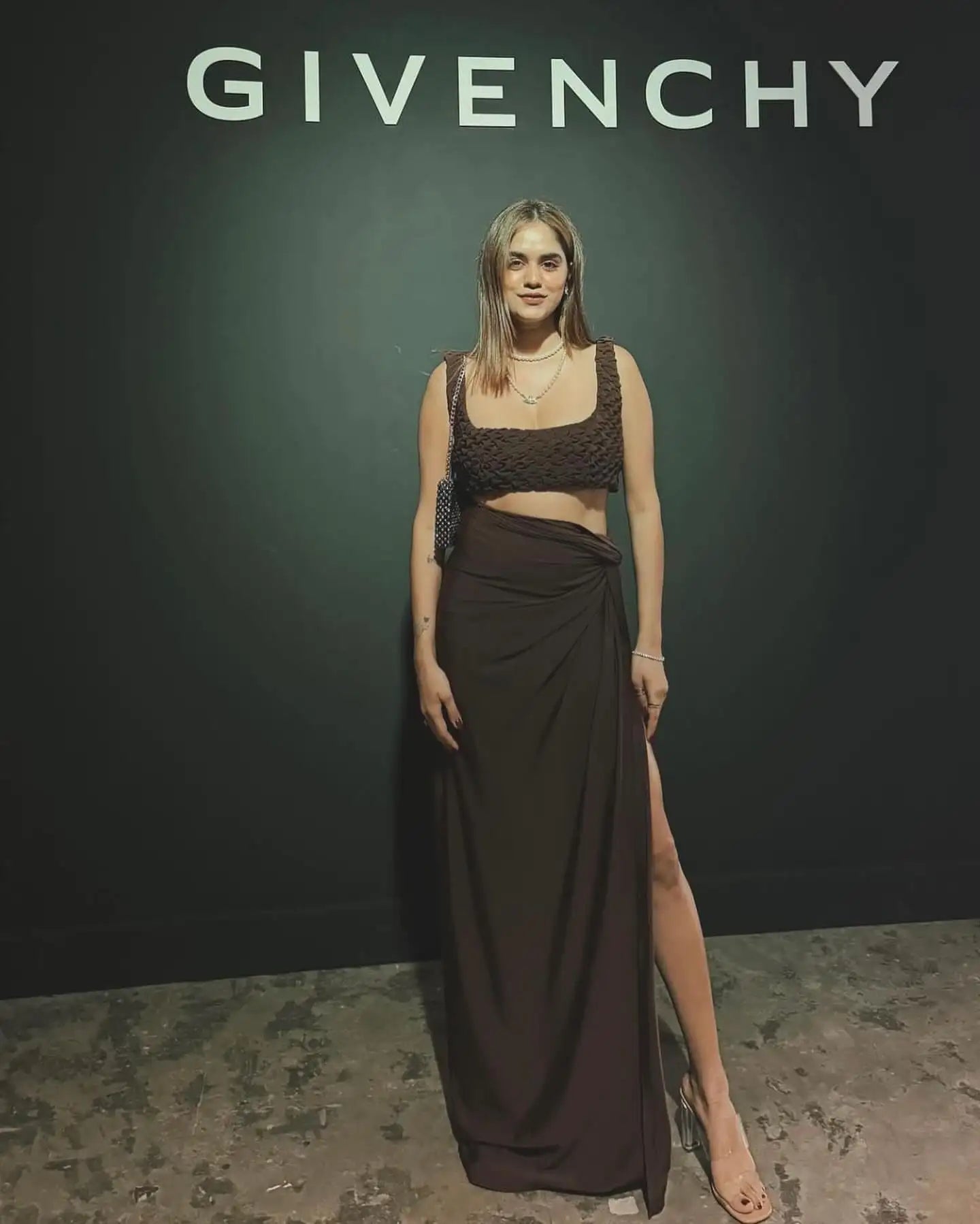 Givenchy black lace crop top with high slit skirt.