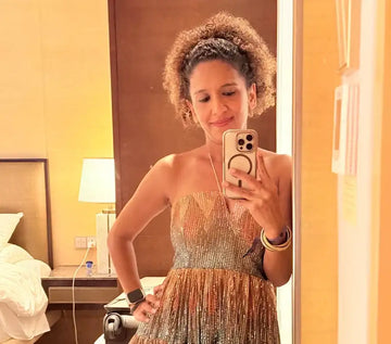 Gold sequined strapless dress with a fitted bodice and flared skirt.