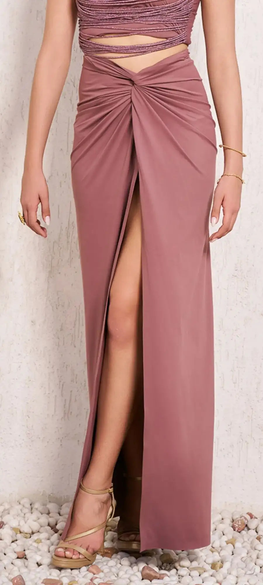 A flowing mauve satin maxi skirt with a high slit and front knot detail.
