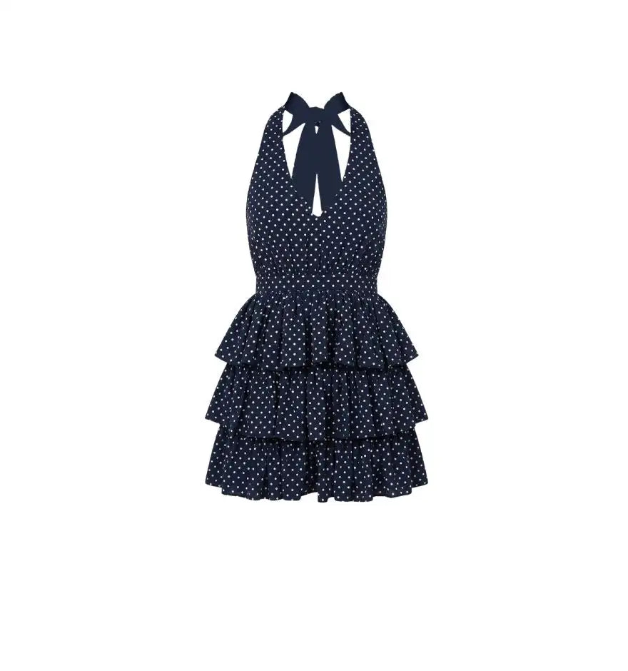 Navy blue halterneck dress with white polka dots and tiered ruffles at the skirt.