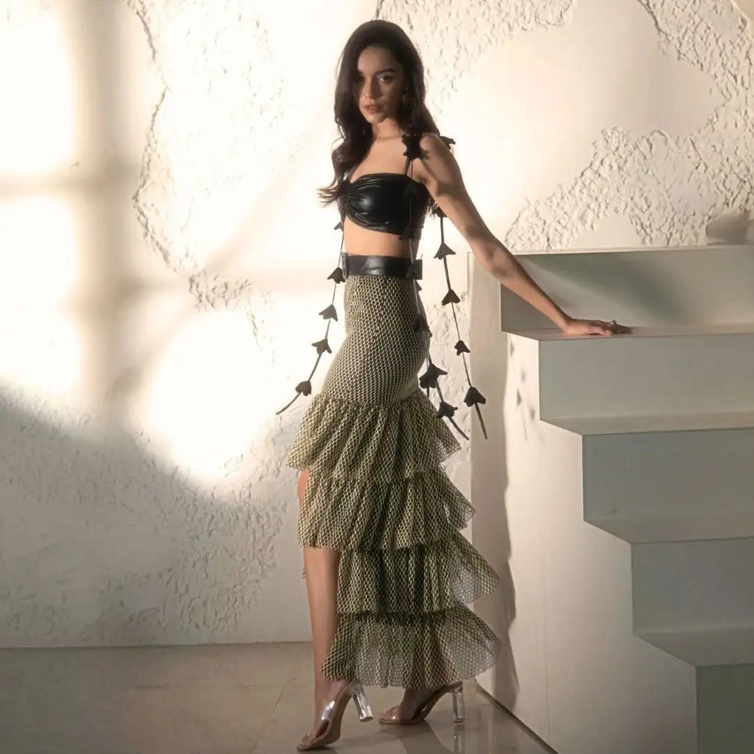 Olive green tiered ruffled skirt with black waistband and silver high heels.shop_this_look_AmCJ7q