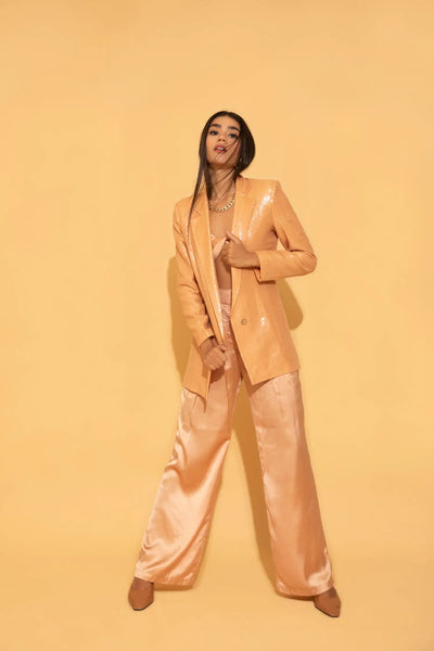 The dazzling peach set from Torqadorn, featuring sequins blazer, crop top and satin pants.