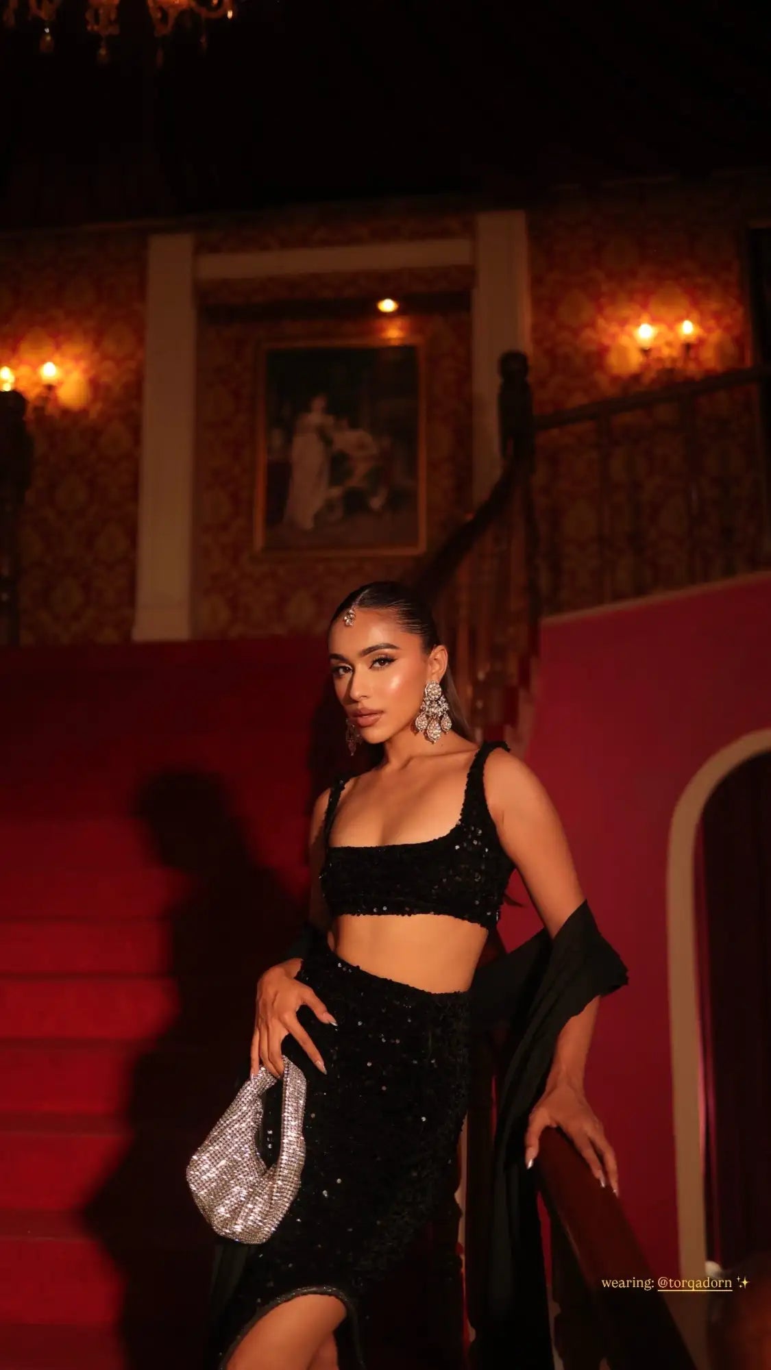 A sparkling silver beaded handbag with a textured, glittering surface and a structured shape.