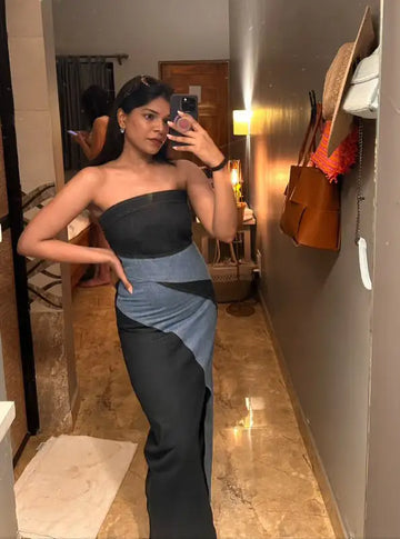 Strapless black and gray dress with a high slit.