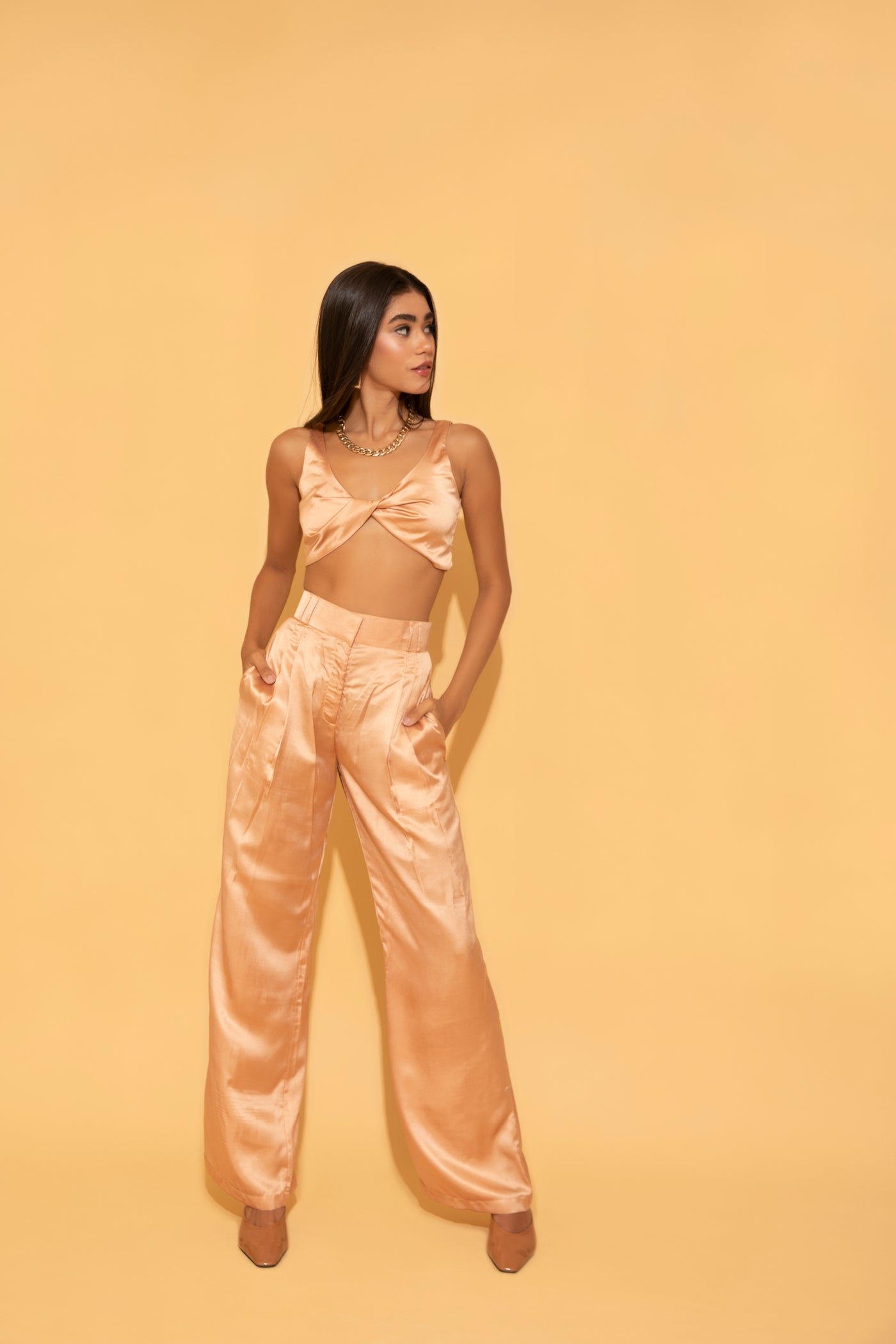 Wide leg peach satin pants paired with peach crop top from Torqadorn