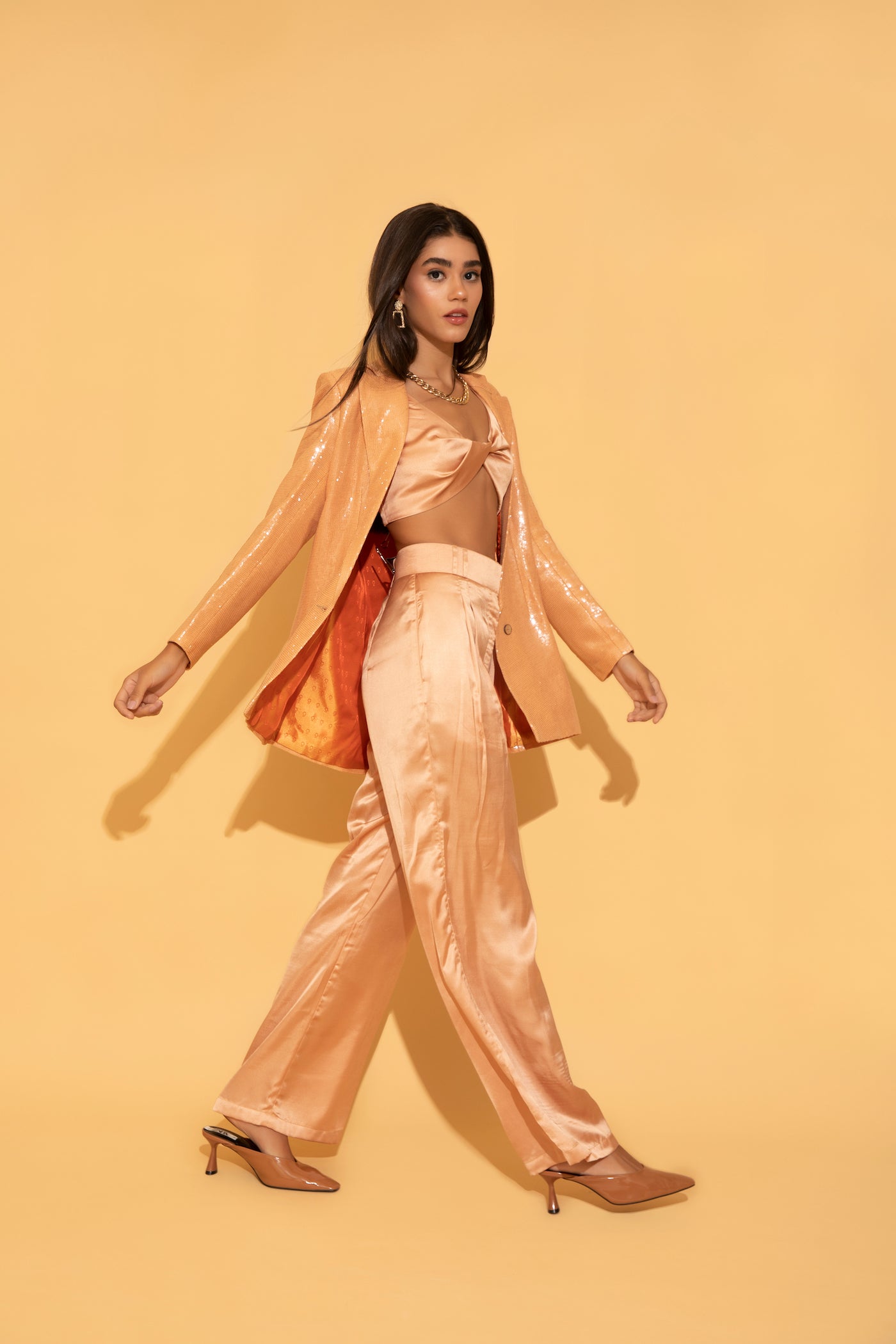 The dazzling peach set from Torqadorn, featuring sequins blazer, crop top and satin pants.