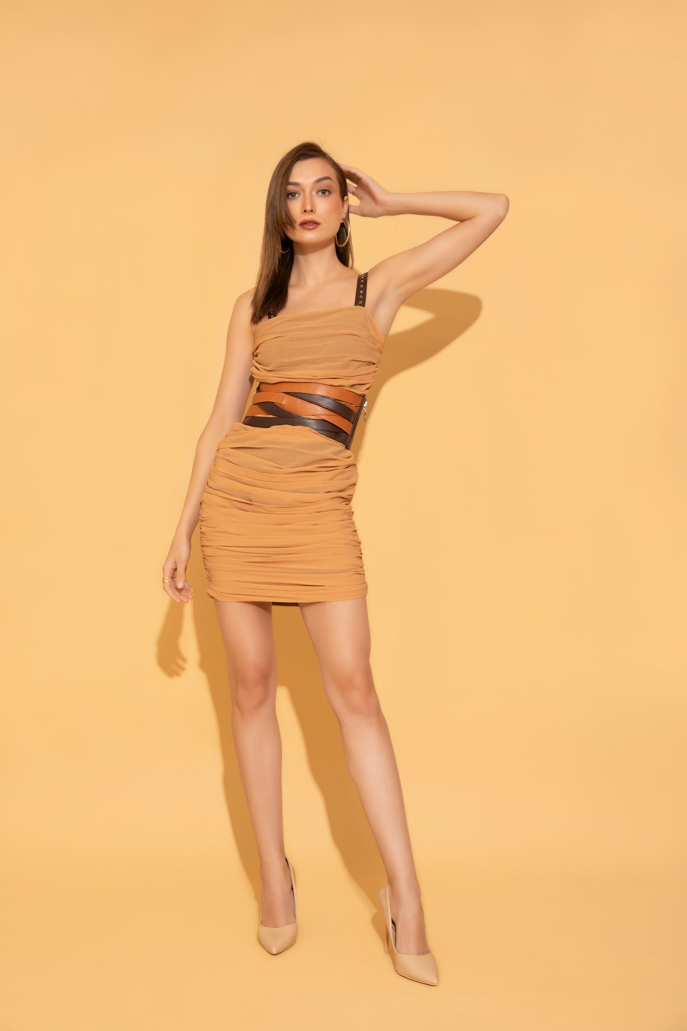 Ruched dress in peach colour featuring rivet detail leather strap and styled with criss-cross leather belt from Torqadorn