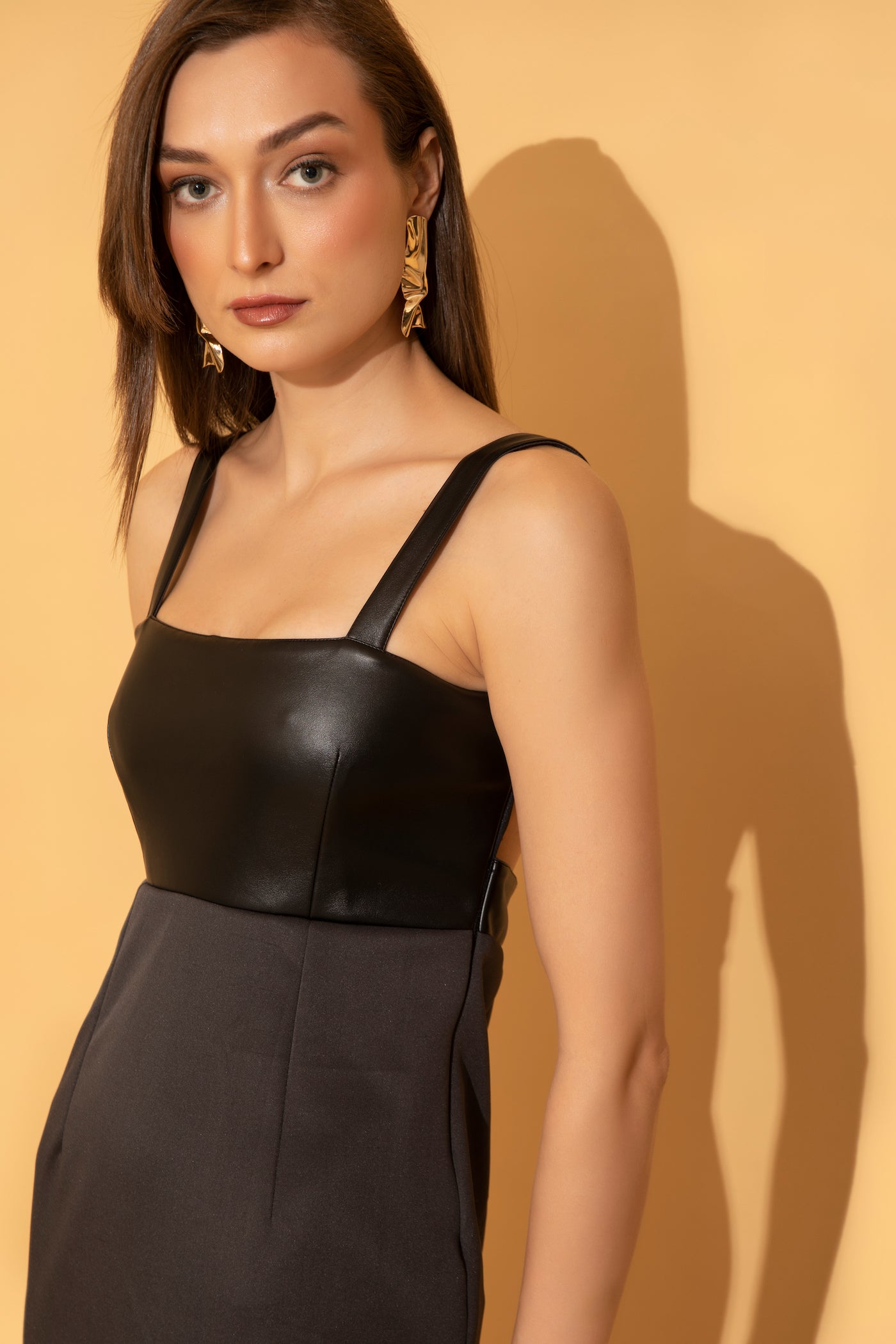 Fine detailing from a black leather bodycon dress from Torqadorn