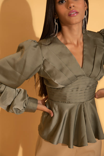 Detailing of green satin blouse with pleats from Torqadorn