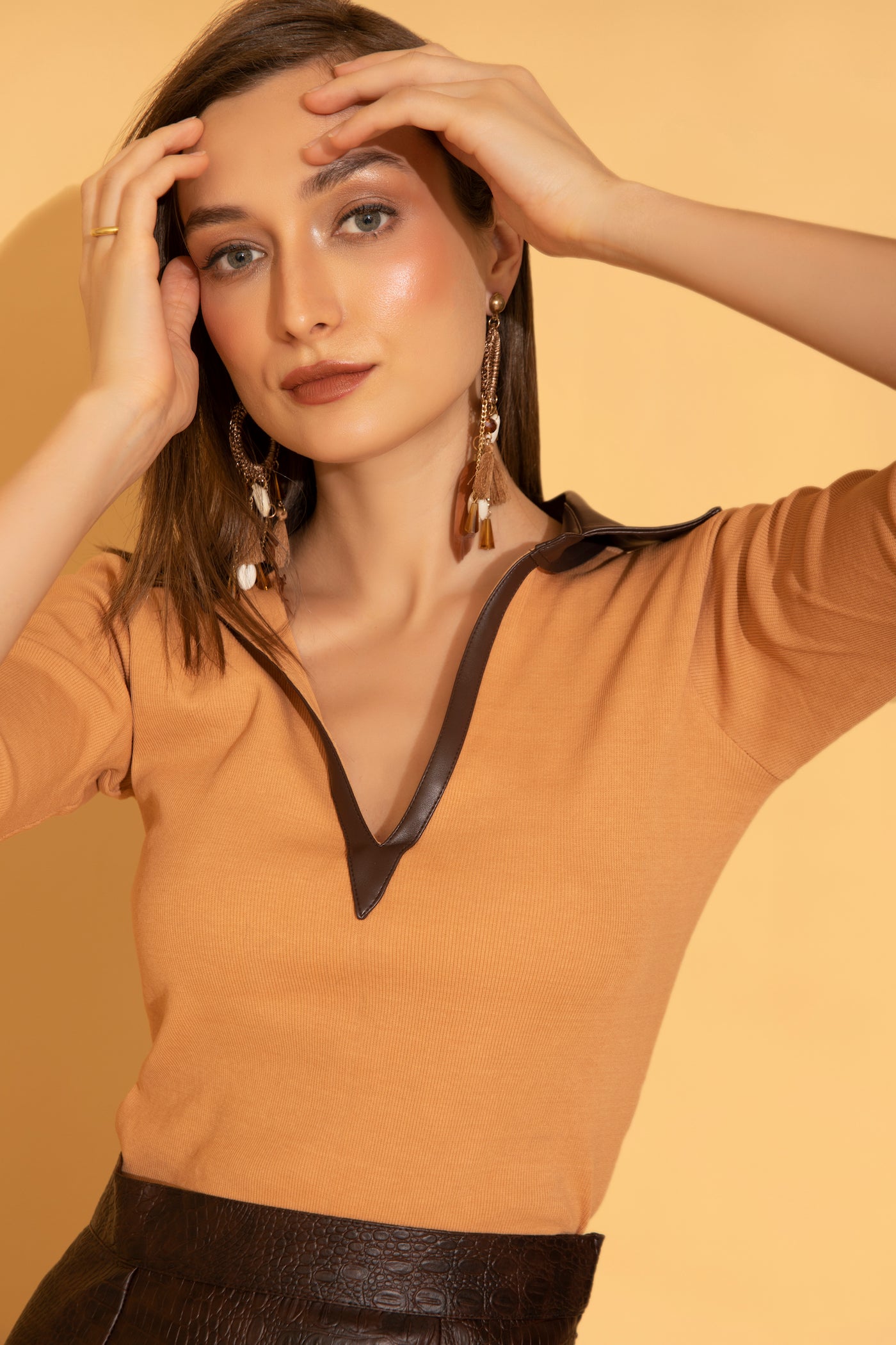 V-neck peach ribbed top with brown leather collar